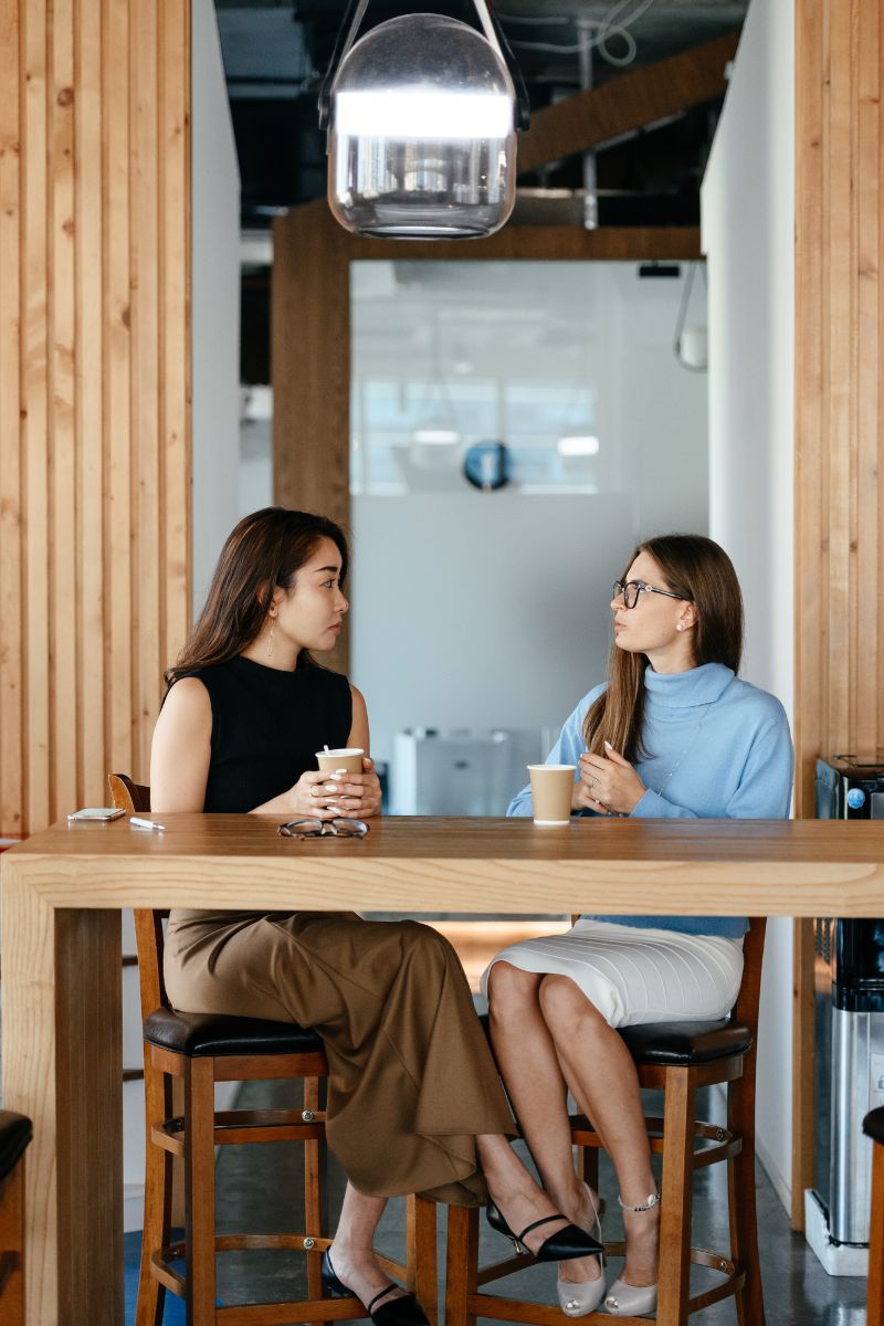two women meeting at coffee shop for partnership