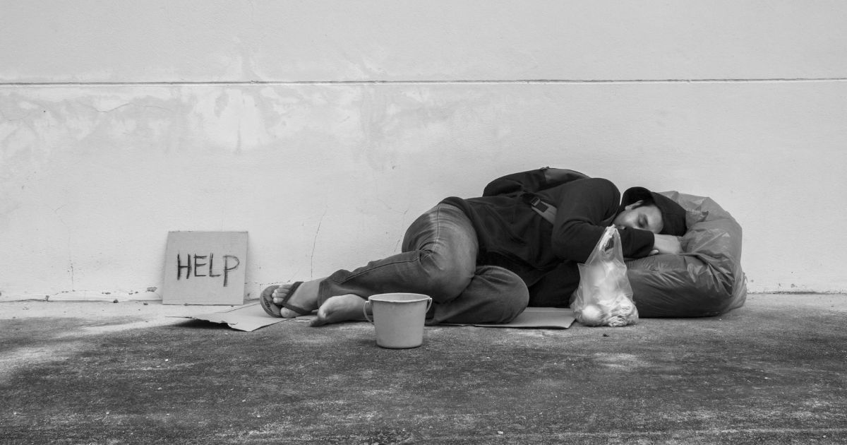 homeless man sleeping on streets